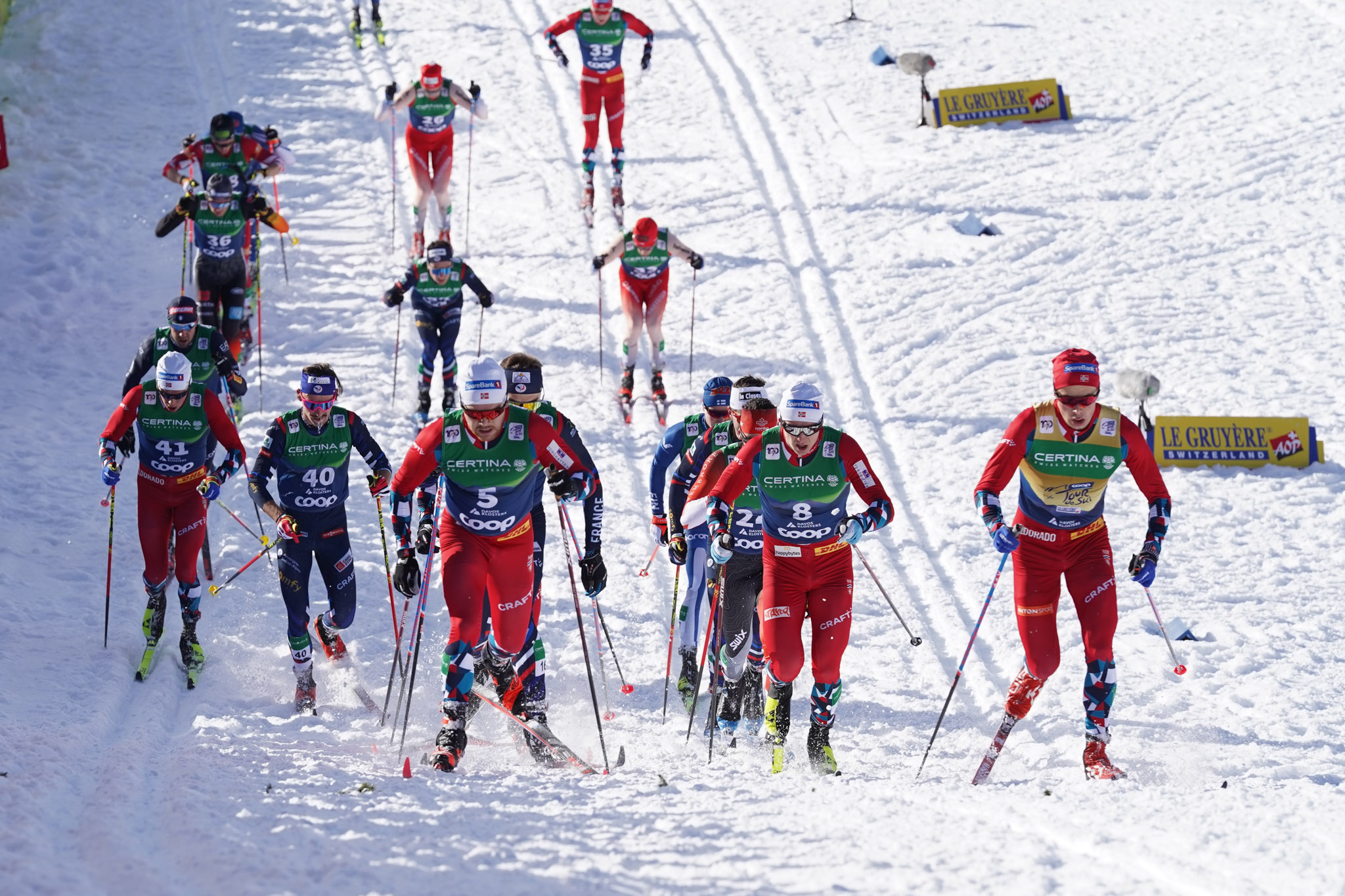 ski racers climbing hill